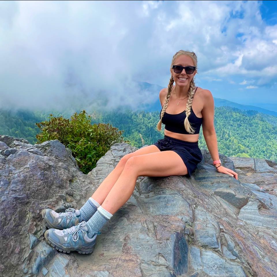 Brittany sitting on the rocks at a Smoky Mountain summit